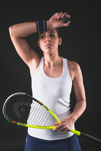 Squash player drying sweat with wristband