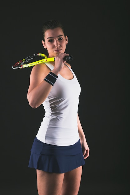 Squash player posing with racket on shoulder