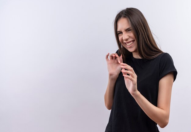 Squeamish young caucasian girl wearing black t-shirt on isolated white background