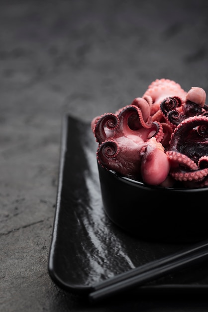 Squid in bowl with chopsticks