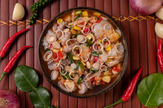 Foto gratuita insalata di calamari con coriandolo, cipolla verde tritata, aglio e mais nel piatto