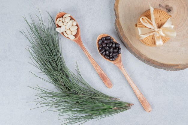 Stack of biscuits tied with ribbon, peanuts and chocolate pieces on wooden board. High quality photo