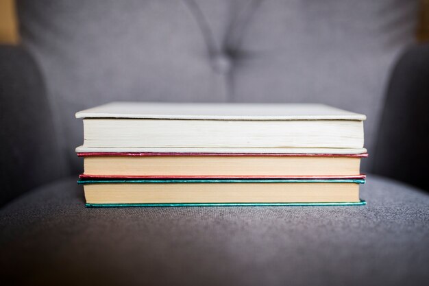 Stack of books on armchair