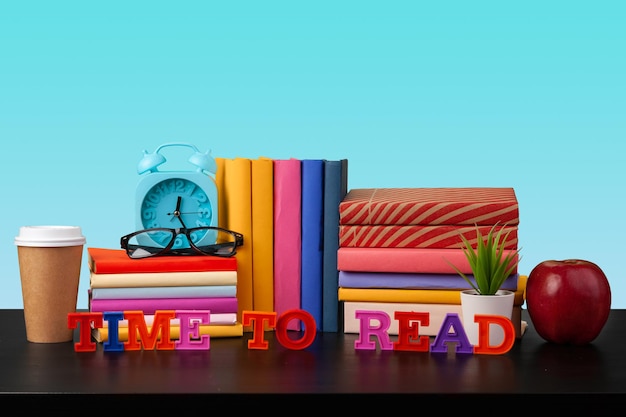 Stack of books on black wooden table