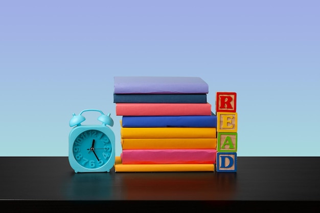 Stack of books on black wooden table