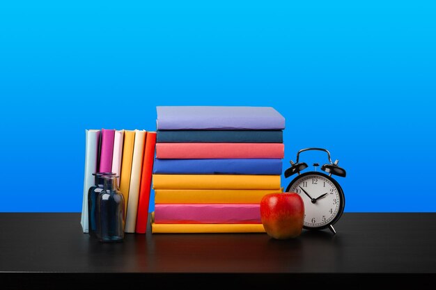 Stack of books on black wooden table