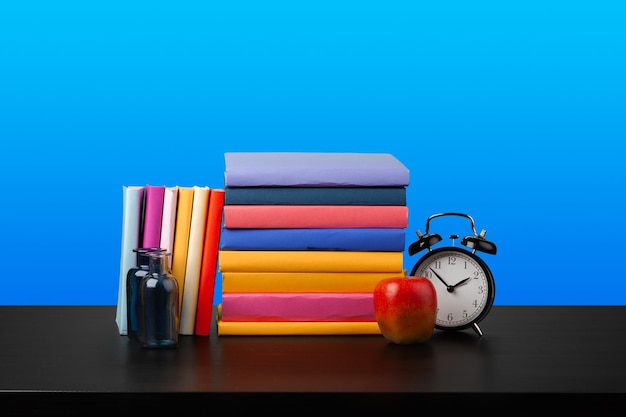 Stack of books on black wooden table