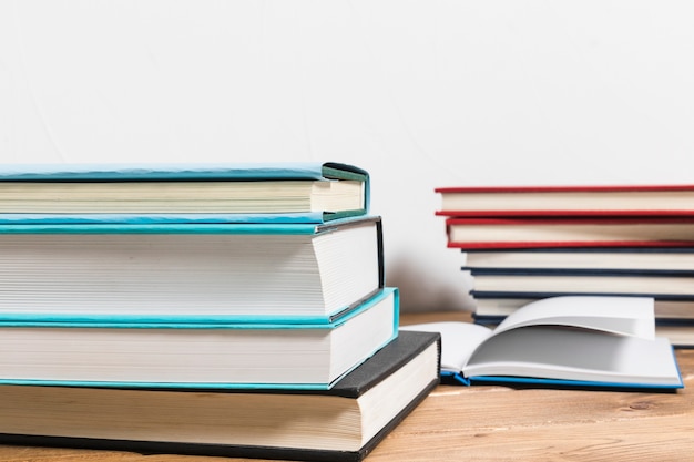 Stack of books on minimalistic wooden table 