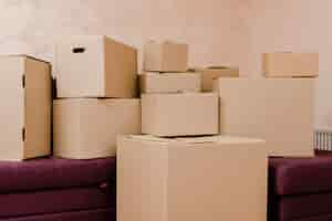 Free photo stack of boxes on couch