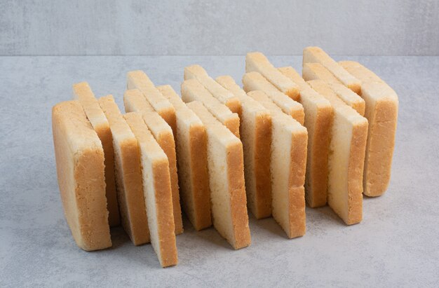 Stack of bread slices on stone surface