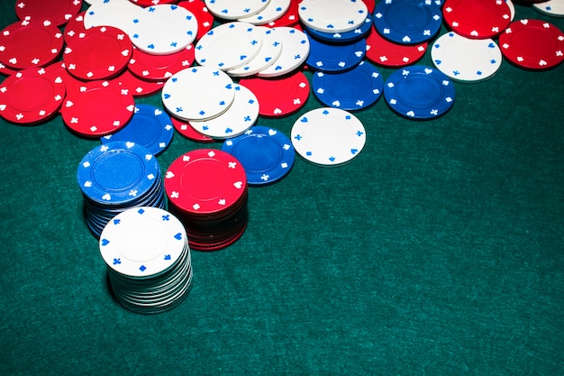 Stack of casino chips on green background