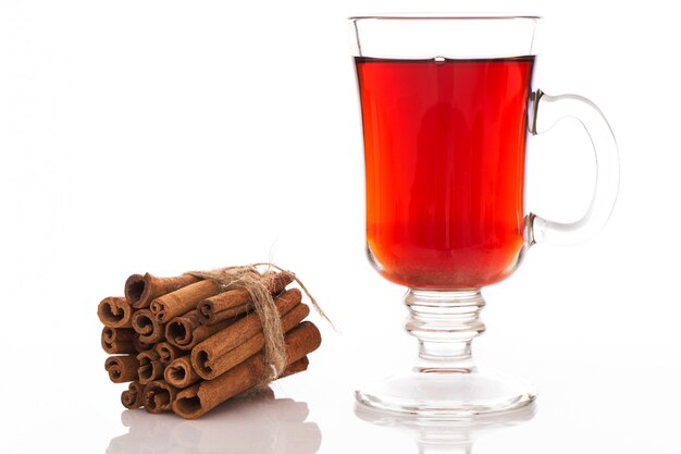 Stack of cinnamon and a glass of tea