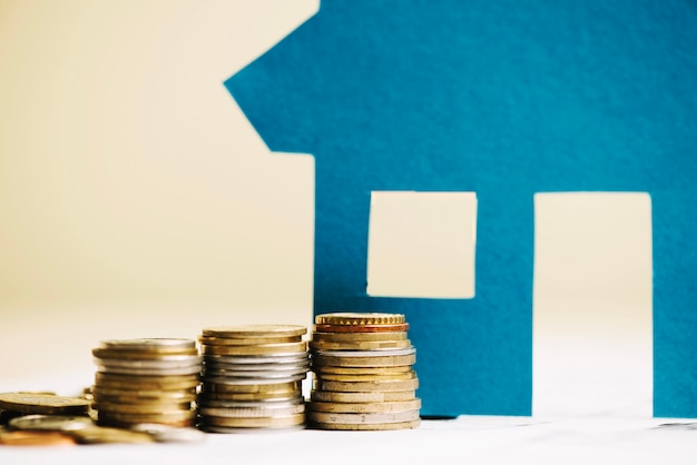 Stack of coins and house