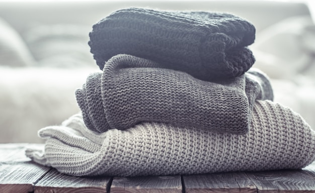 Free photo stack of cozy knitted sweaters in different colors.