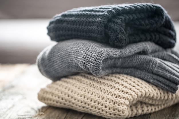 stack of cozy knitted sweaters