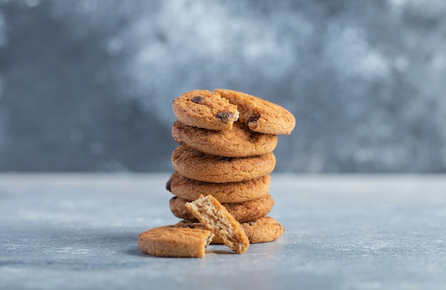 Stack of delicious chocolate chip cookies on marble background