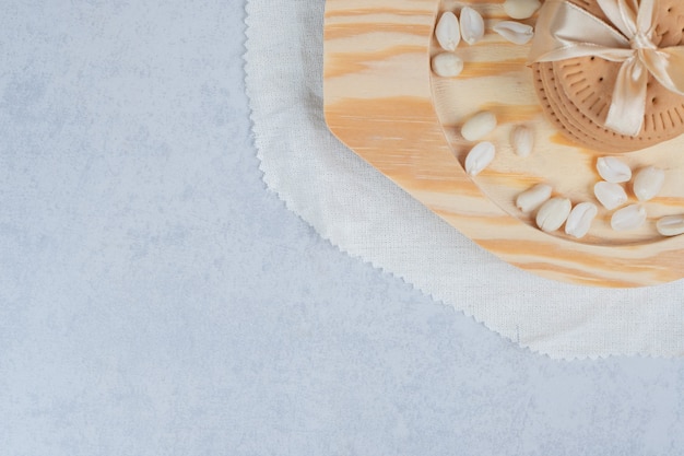 Stack of festive biscuits and peanuts on wooden plate. High quality photo