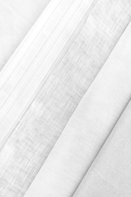 Stack of folded gray and white woven fabric patterned background