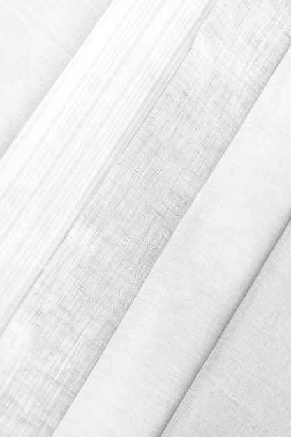 折り畳まれた灰色と白の織物のパターン化された背景のスタック