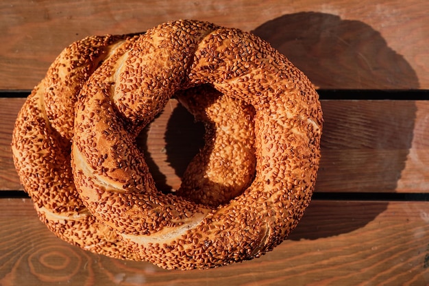 Stack of freshly baked Turkish bagel simit Wooden background View from above