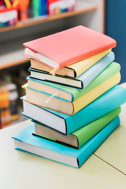 Stack of multicolored books on table