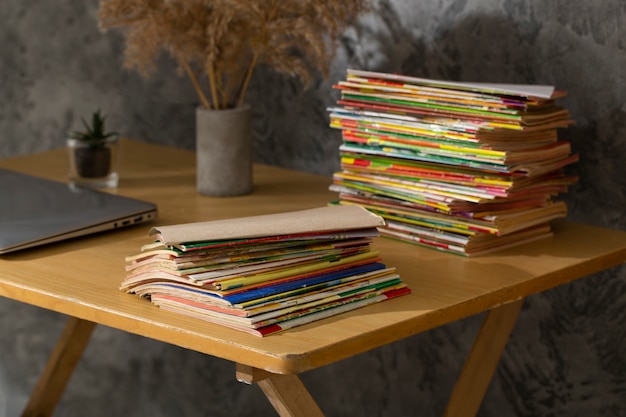 Stack of old coming book strips on wooden desk
