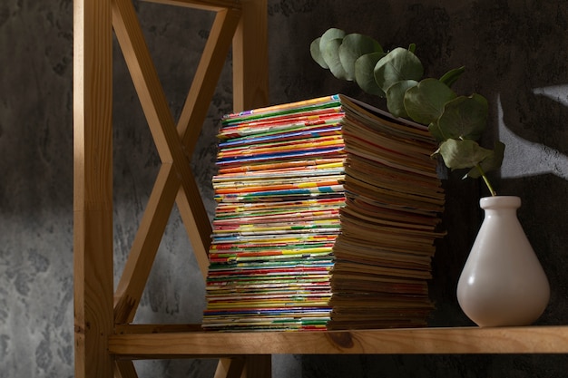 Free photo stack of old coming book strips on wooden shelf