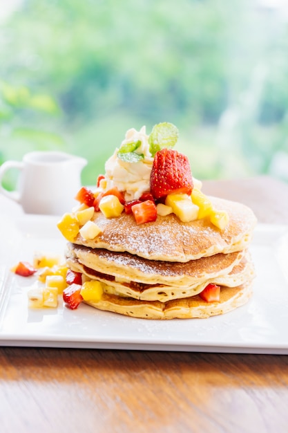 Stack of pancake with strawberry on top