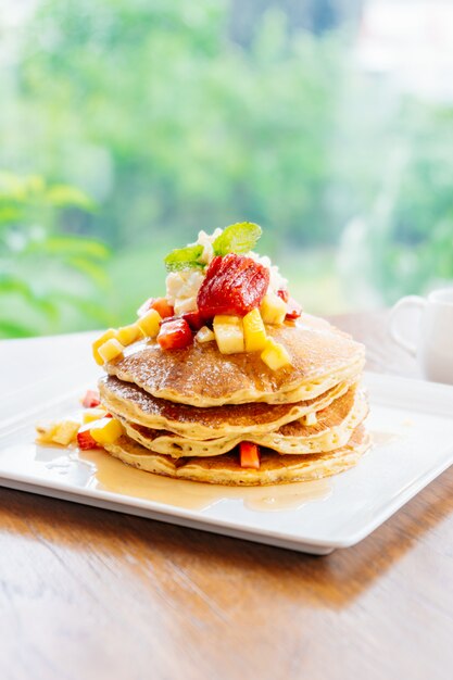 Stack of pancake with strawberry on top