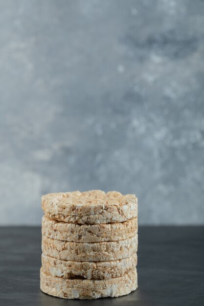 Stack of puffed rice cakes on marble surface