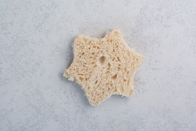 Free photo stack of star shaped bread slice on stone surface