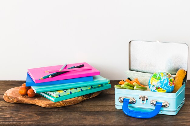 Stack of stationery near lunchbox