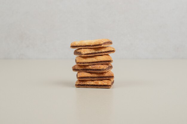 Stack of sweet biscuits on gray surface
