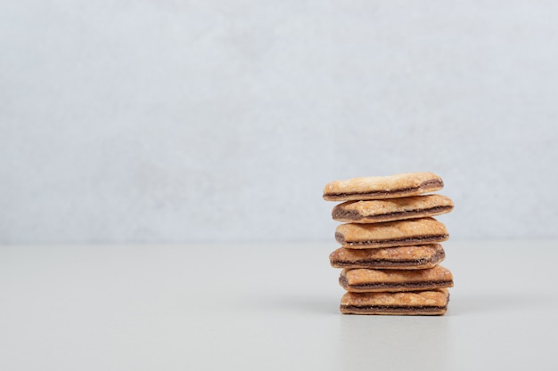 Stack of sweet biscuits on gray surface