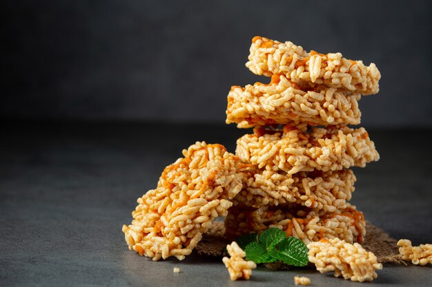 the stack of Thai snack KAO TAN or rice cracker on dark floor