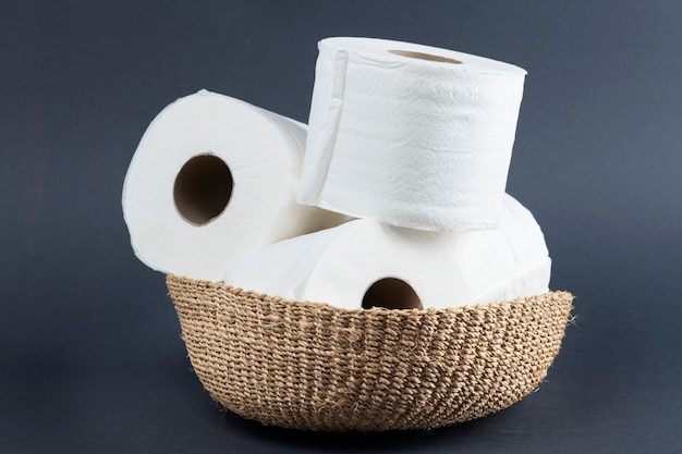 Stack of toilet paper rolls on wicker basket