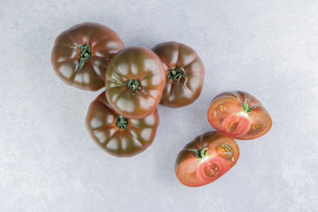 A stack of tomatoes on the marble surface