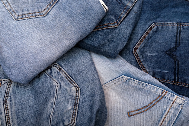 Premium Photo | Stack of various shades of blue jeans