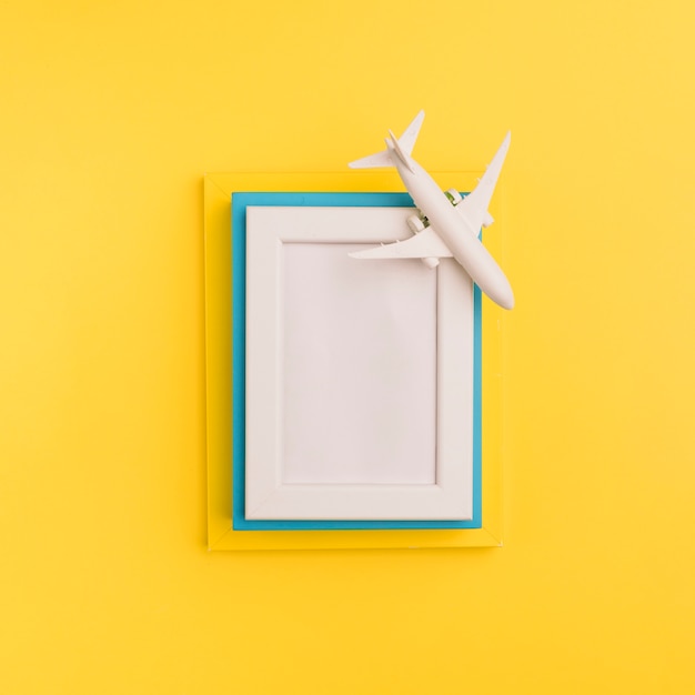 Stack of wooden frames with toy plane