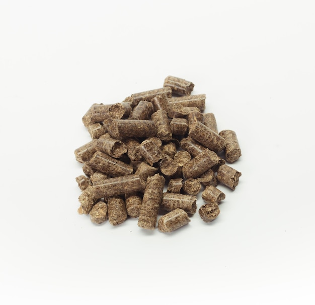 Stack of wooden pellets for bio energy white background isolated
