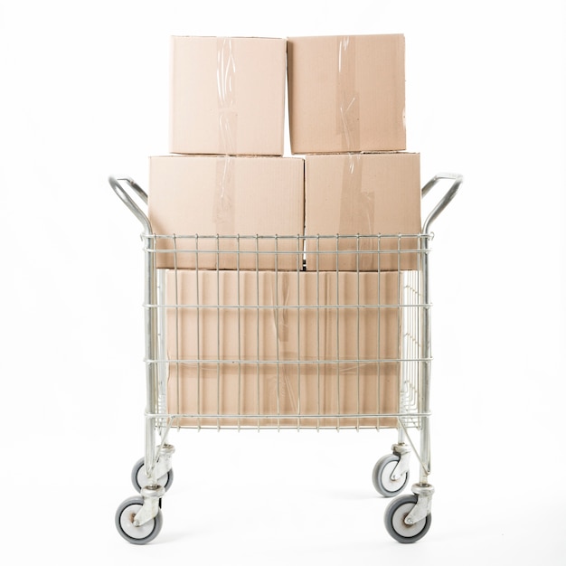 Stacked of cardboard box on trolley against white background