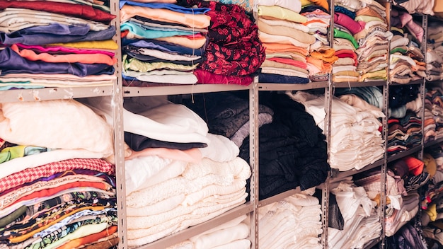 Stacked of colorful fabrics in the shelf