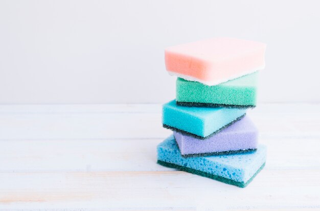 Stacked of colorful sponges on desk