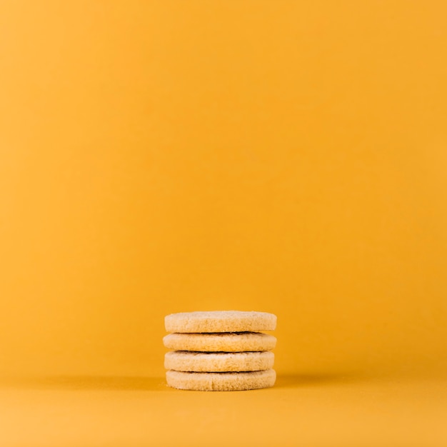 Stacked cookies on yellow background