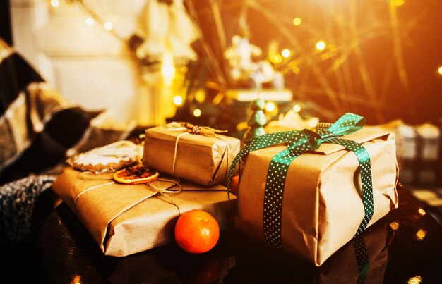 Stacked gifts with green bows and an orange