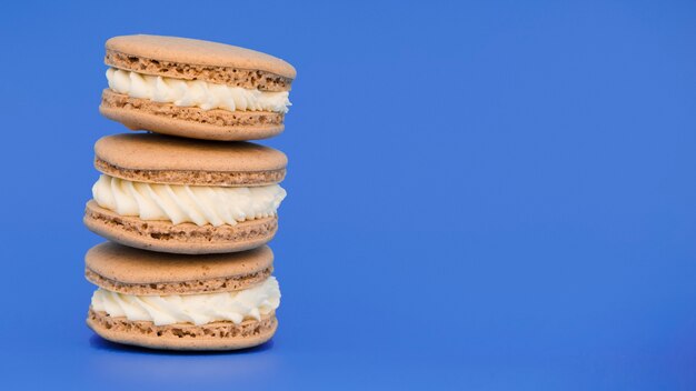 Stacked of macaroons on blue background