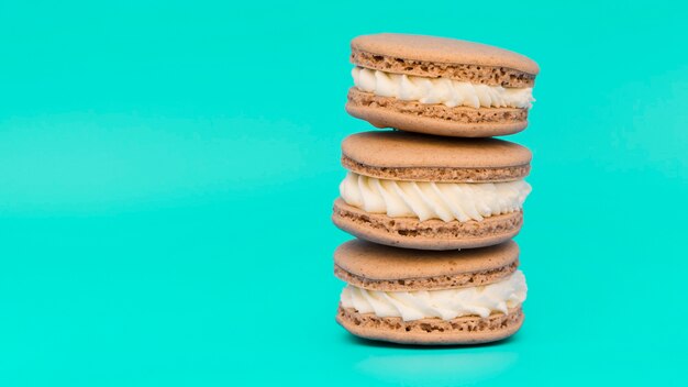 Stacked of macaroons on turquoise background