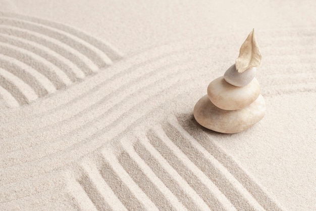 Stacked zen marble stones sand background in mindfulness concept