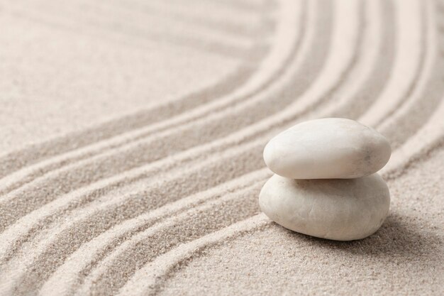 Stacked zen marble stones sand background in mindfulness concept