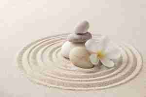 Free photo stacked zen stones sand background art of balance concept